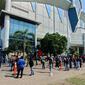 people line up outside large church building