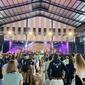 young people face a flashy stage in an open air auditorium