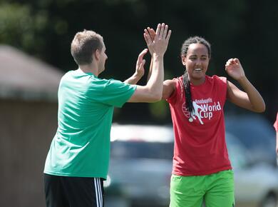 two soccer players high five