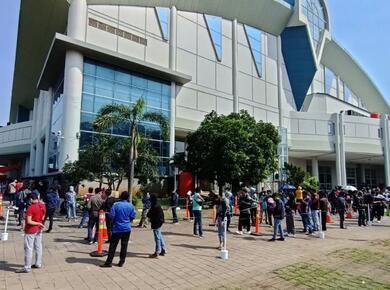 people line up outside large church building