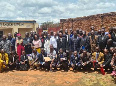 a large group of Africans pose for a photo