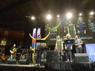 music team on stage with arms raised