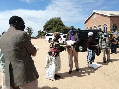 line of people hand over relief supplies