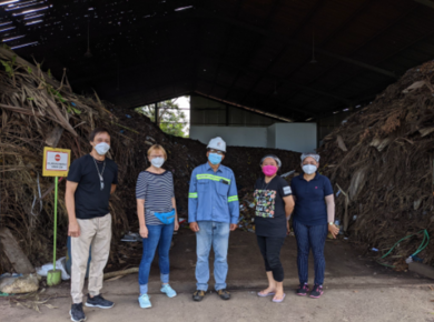 5 people stand in front of compost pile