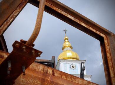 cathedral spire seen through raw metal frame